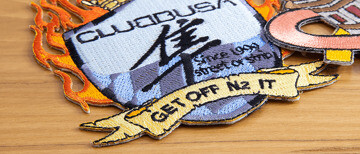 Embroidered patch with a hot cut edge